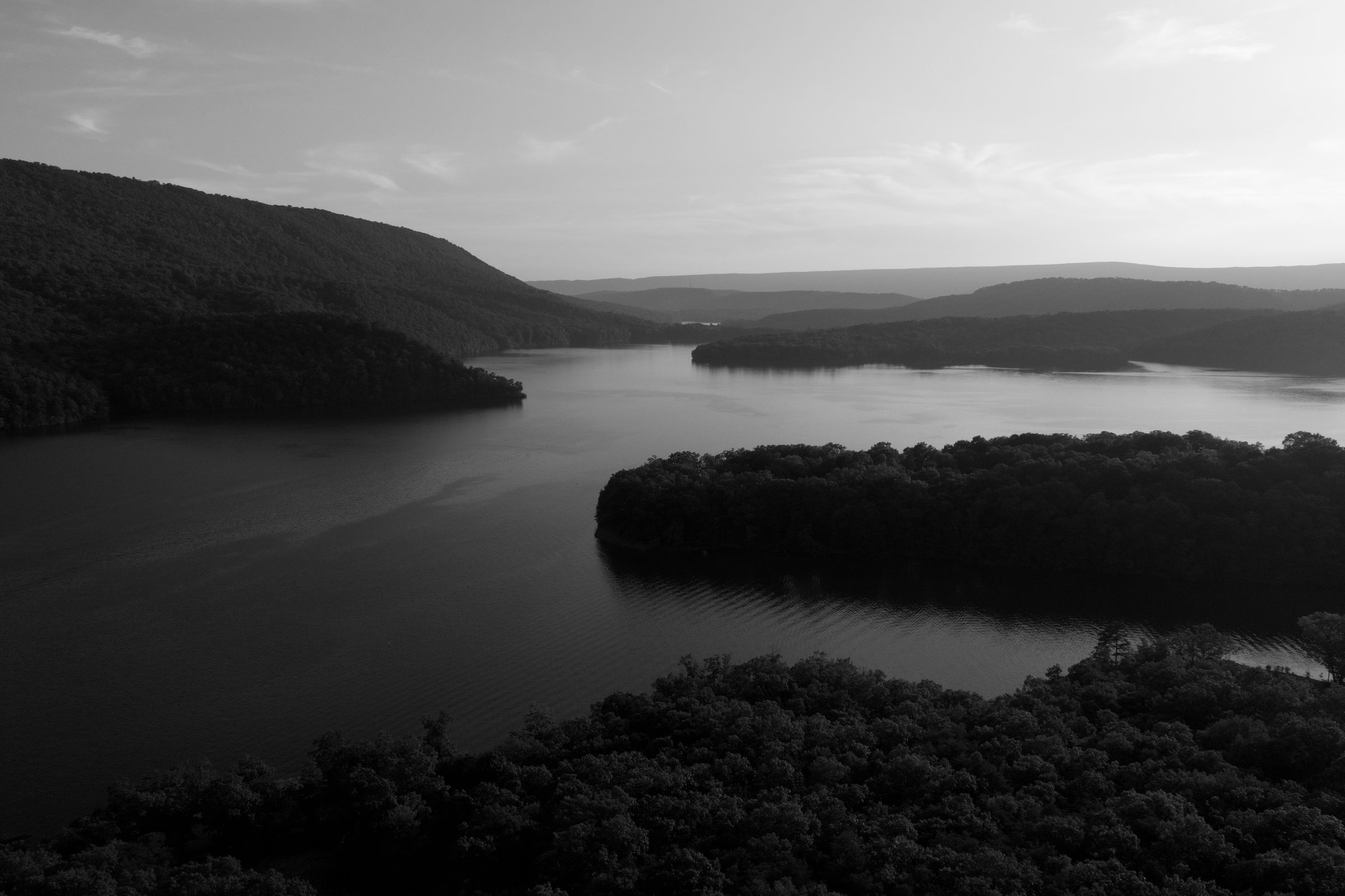 Raystown Lake at dusk, winding between forested ridges above Seven Points Marina
